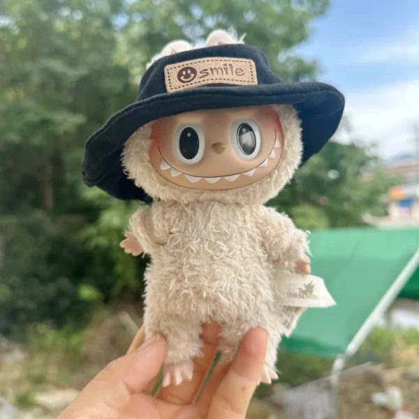 Cute Labubu Doll Wearing a Black Denim Hat with 'smile' Label in a Natural Outdoor Setting - Adorable Hat Accessory for Labubu Dolls | Labubu Doll Clothing & Accessories
