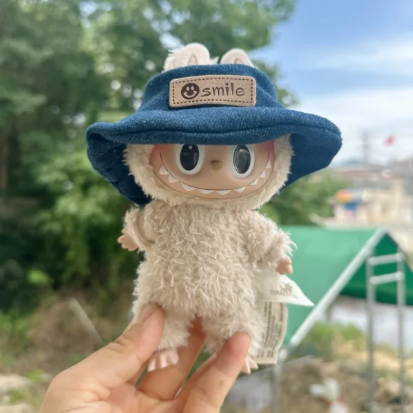 Cute Labubu Doll Wearing a Blue Denim Hat with 'smile' Label in a Natural Outdoor Setting - Adorable Hat Accessory for Labubu Dolls | Labubu Doll Clothing & Accessories