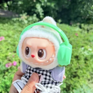 Cute Labubu Doll Wearing a Green Headphone in a Natural Green Setting - Adorable Earphone Accessory | Labubu Doll Clothing & Accessories