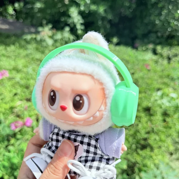 Cute Labubu Doll Wearing a Green Headphone in a Natural Green Setting - Adorable Earphone Accessory | Labubu Doll Clothing & Accessories