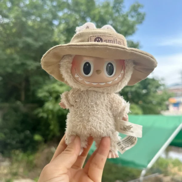 Cute Labubu Doll Wearing a Khaki Denim Hat with 'smile' Label in a Natural Outdoor Setting - Adorable Hat Accessory for Labubu Dolls | Labubu Doll Clothing & Accessories