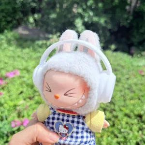 Cute Labubu Doll Wearing a White Headphone in a Natural Green Setting - Adorable Earphone Accessory | Labubu Doll Clothing & Accessories